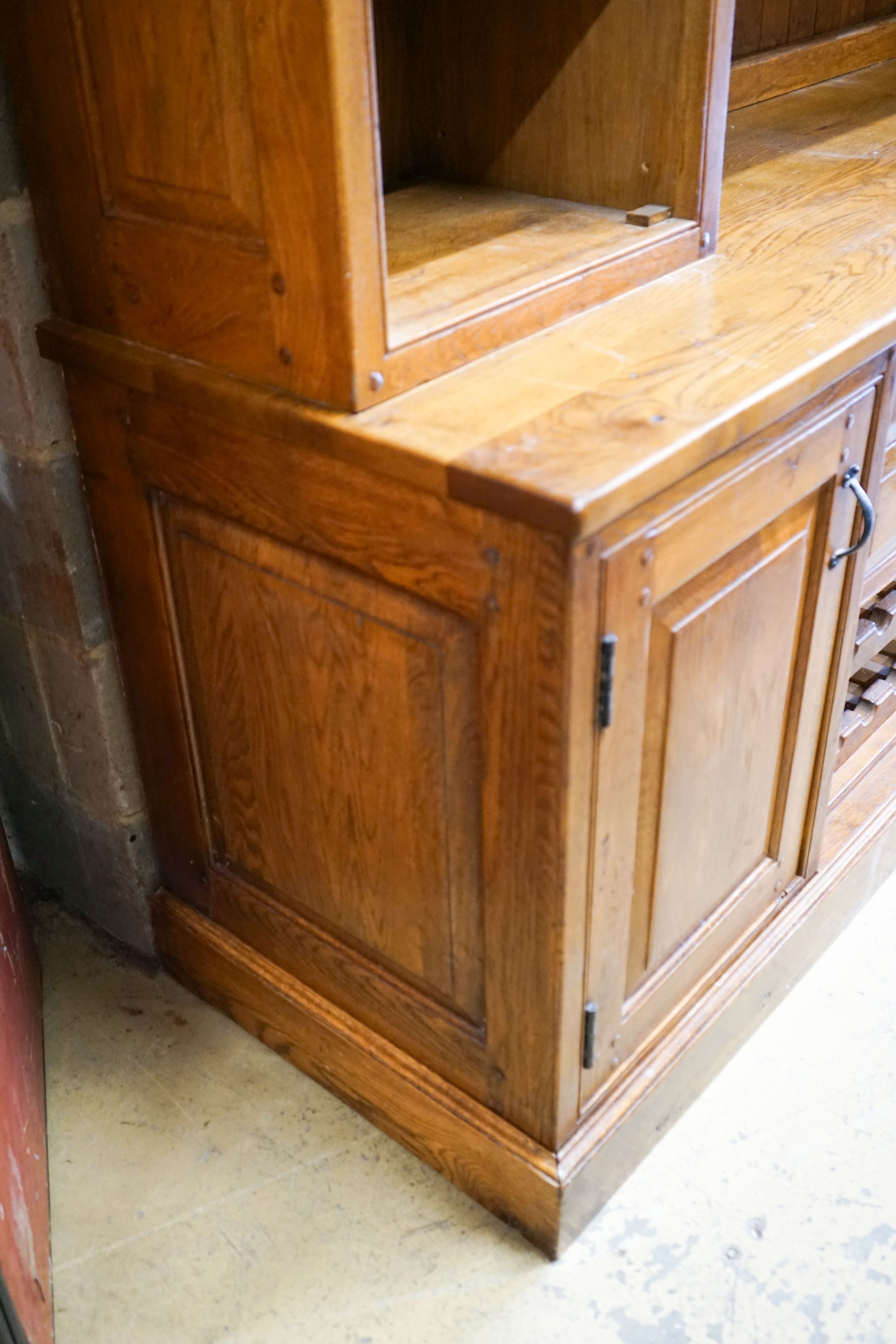 A large reproduction oak dresser with wine bottle storage, length 244cm, depth 60cm, height 201cm